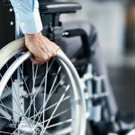 Wheelchair,,disability,and,man,hand,holding,wheel,in,a,hospital